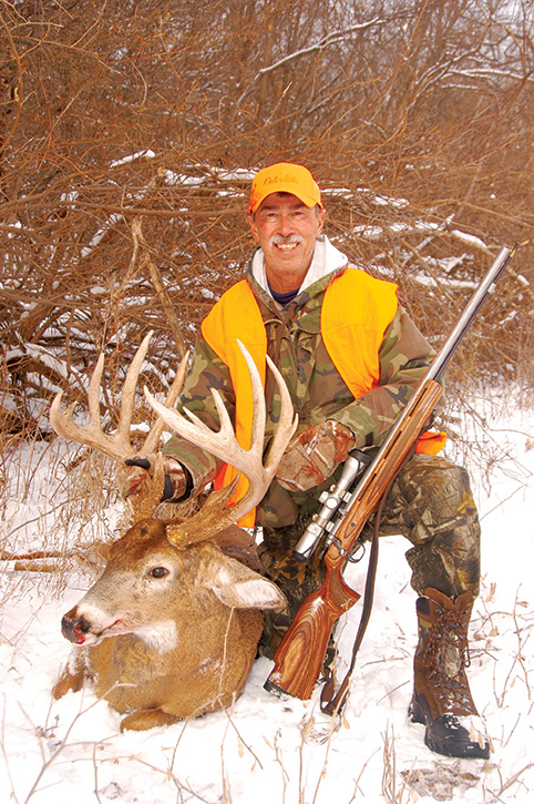 Hunter with whitetail deer he shot
