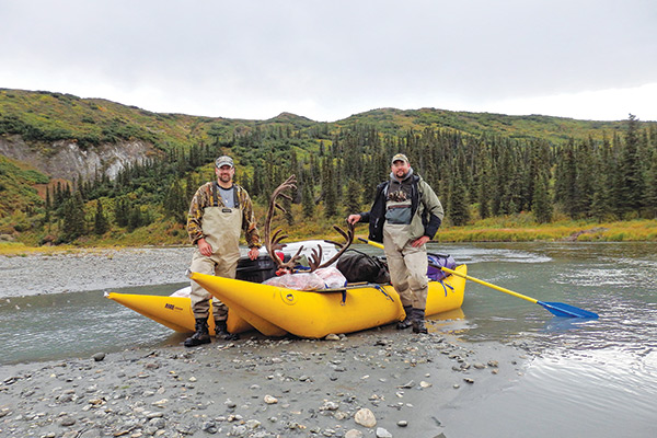Joe Classen with caribou in an inflatable boat